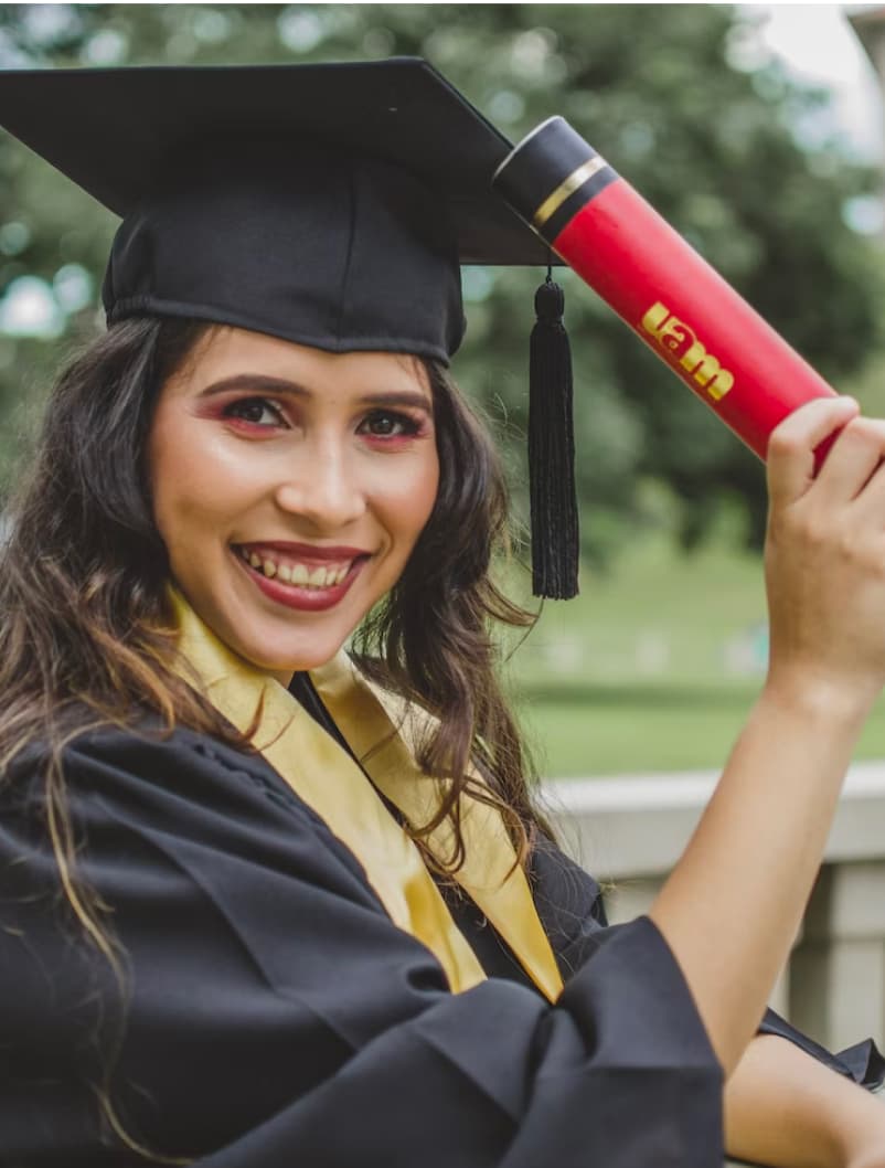 Graduate celebrating wearing a cap and gown