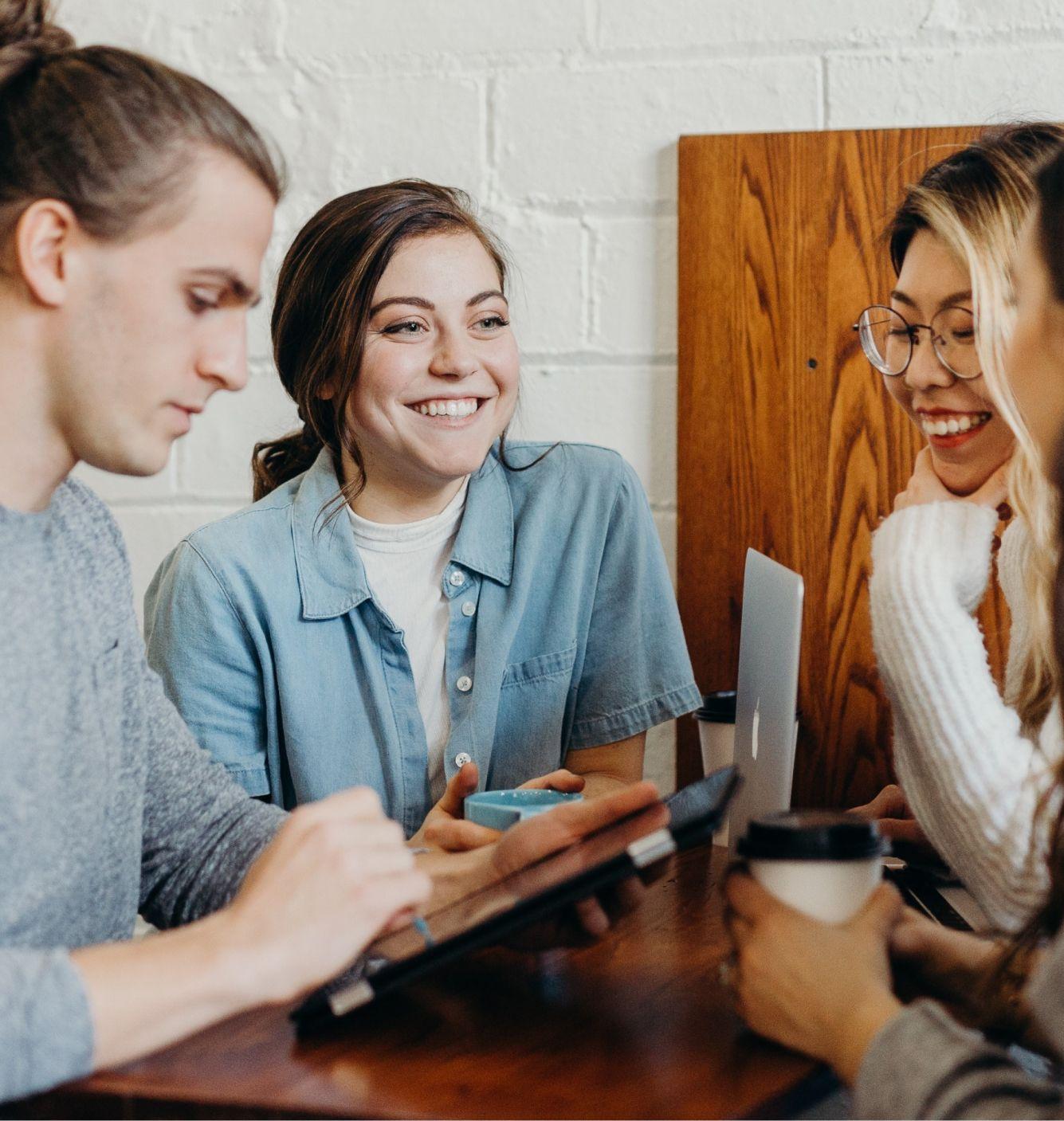 Students talking seated around a table