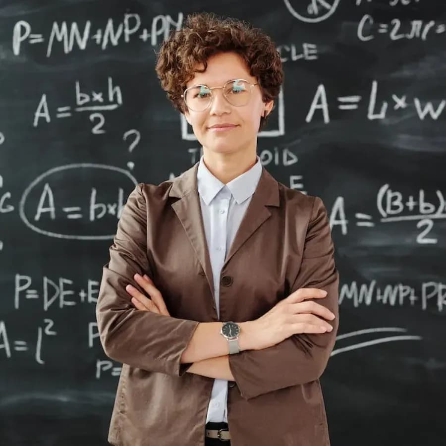 A confident math teacher stands with arms crossed in front of a blackboard filled with complex equations. The teacher exudes professionalism and expertise in the subject matter.