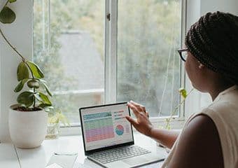 Woman looking at data on a laptop