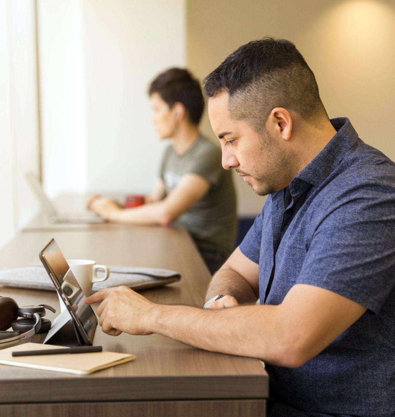 Student using a tablet in a desk